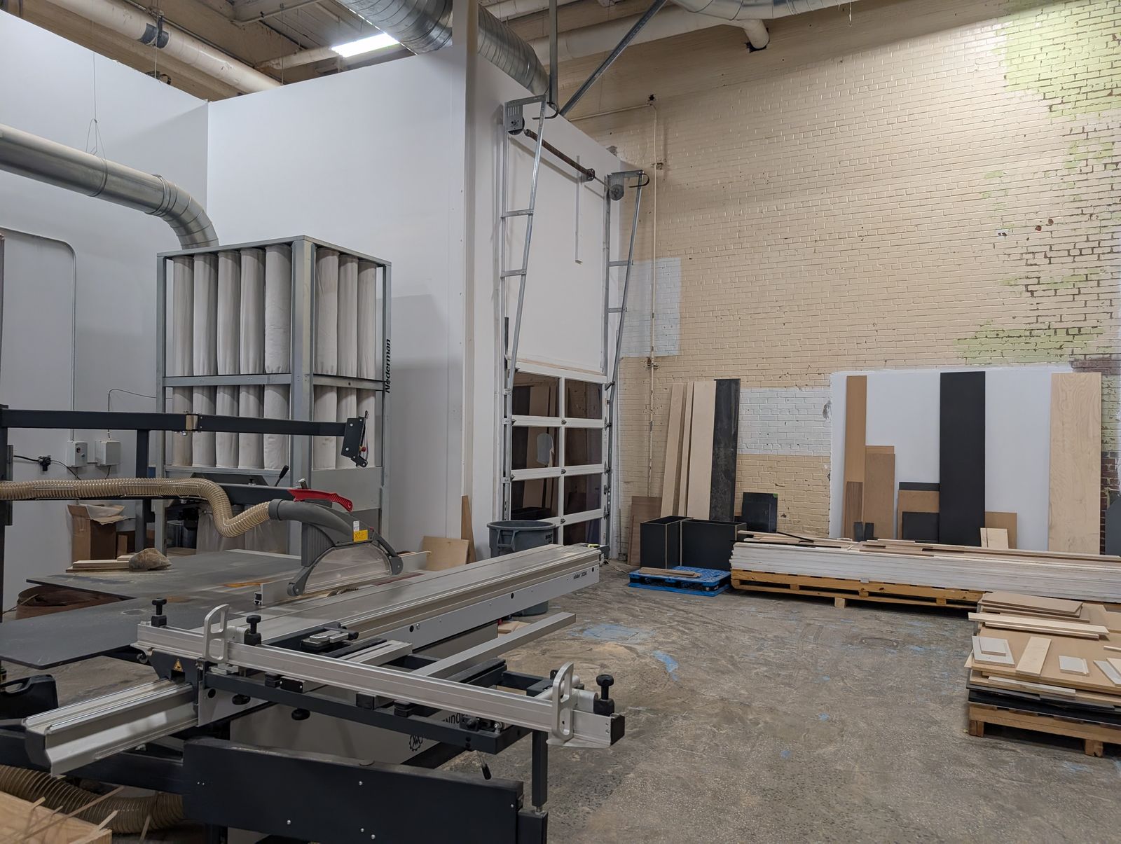 Shop interior with sliding table saw and dust collection
