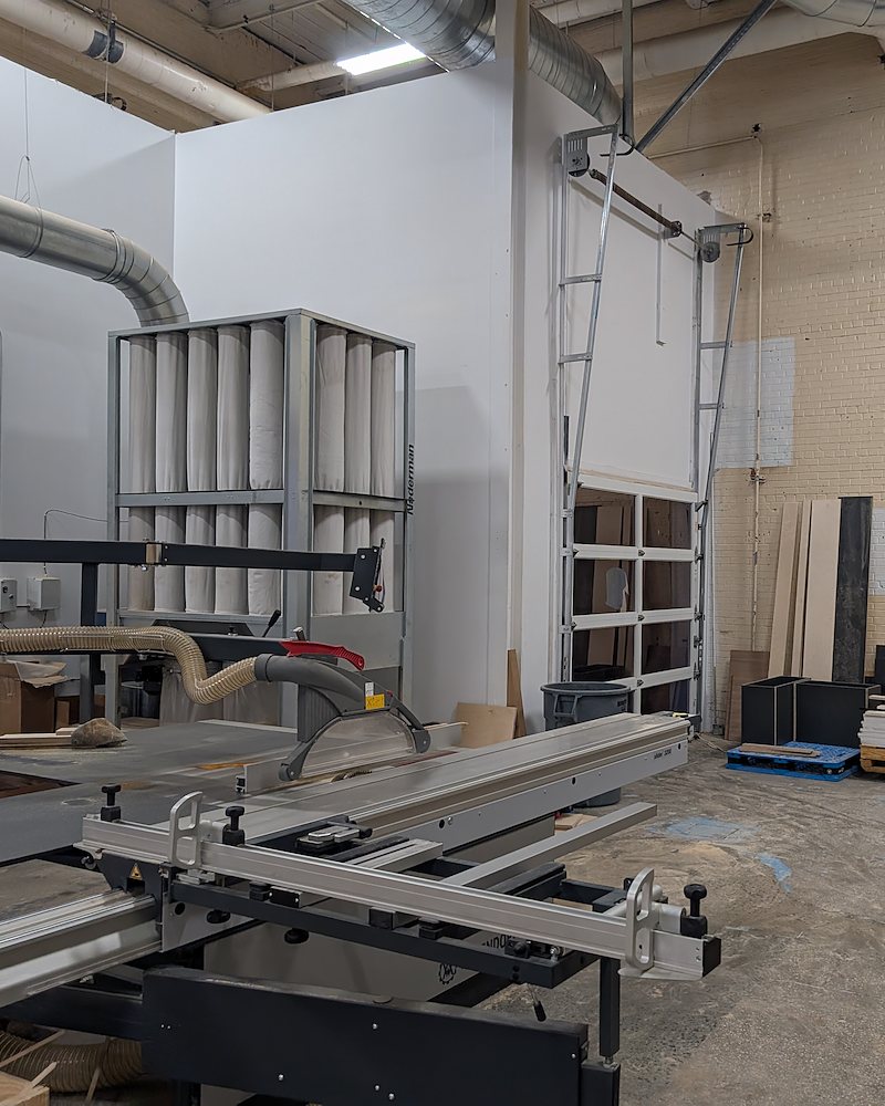 Shop interior with sliding table saw and dust collection