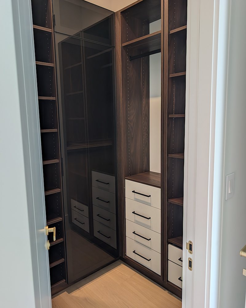 Walk-in closet with smoke glass wardrobe and drawer towers